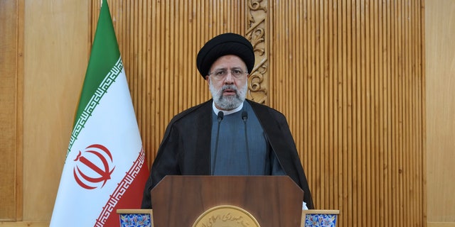 Iranian President Ebrahim Raisi speaks before departing Tehran's Mehrabad Airport for a trip to Oman May, 23, 2022. 