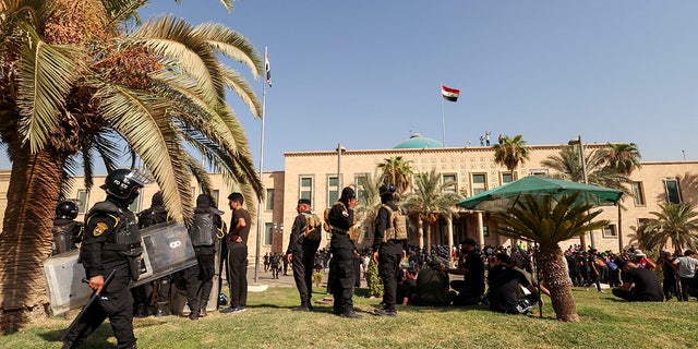 Iraqi security forces keep guard as supporters of Iraqi populist leader Moqtada al-Sadr protest at the Republican Palace in the Green Zone, in Baghdad, Iraq August 29, 2022. REUTERS/Alaa Al-Marjani