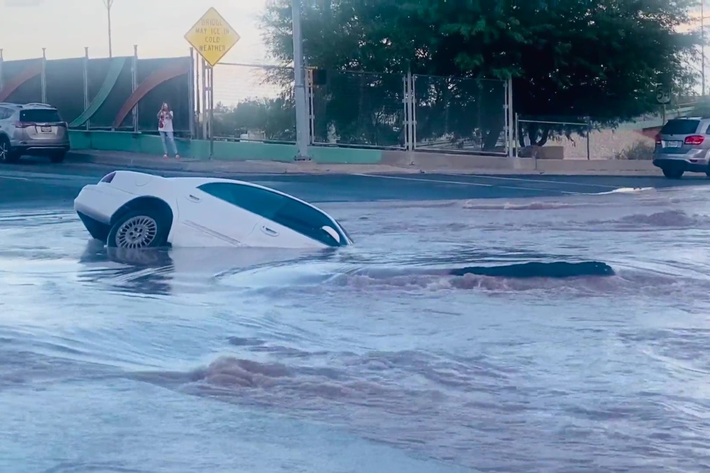 The woman was driving her white sedan along Yandell and Gateway South around 6:40 P.M. when a massive sinkhole opened up beneath her car.