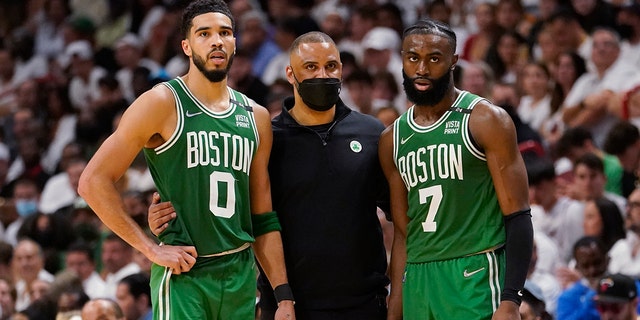 Boston Celtics head coach Ime Udoka, center, speaks to Boston Celtics forward Jayson Tatum (0) and guard Jaylen Brown (7) during Game 1 of the Eastern Conference Finals against the Miami Heat, May 17, 2022, in Miami.