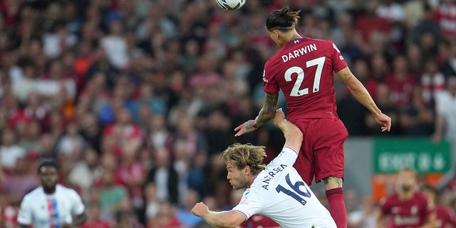 Liverpool's Darwin Nunez, top, heads the ball past Crystal Palace's Joachim Andersen during an English Premier League soccer match between Liverpool and Crystal Palace at Anfield Stadium in Liverpool, England, Monday, Aug. 15, 2022.