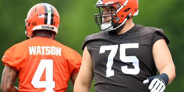 Joel Bitonio (75) and Deshaun Watson (4) of the Cleveland Browns warm up during the Browns mandatory minicamp at CrossCountry Mortgage Campus on June 14, 2022, in Berea, Ohio.