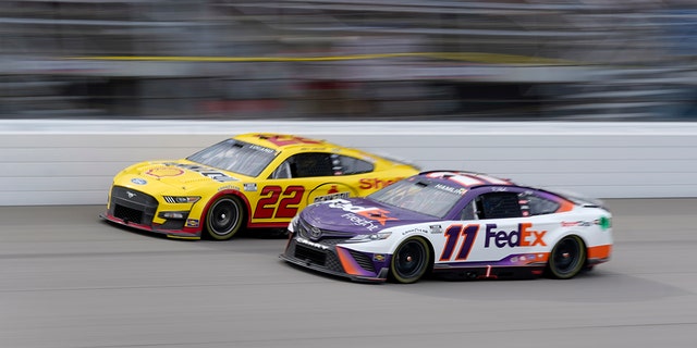 Denny Hamlin (11) and Joey Logano (22) race in the FireKeepers Casino 400 at Michigan International Speedway in Brooklyn, Michigan, Aug. 7, 2022.