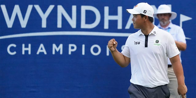 Joohyoung Kim, right, of South Korea, reacts after winning the Wyndham Championship golf tournament in Greensboro, N.C., Sunday, Aug. 7, 2022. 