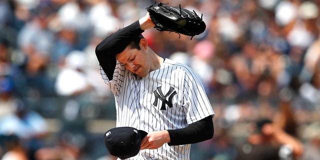 New York Yankees starting pitcher Jordan Montgomery pauses before pitching against the Kansas City Royals during the fifth inning of a baseball game Sunday, July 31, 2022, in New York.