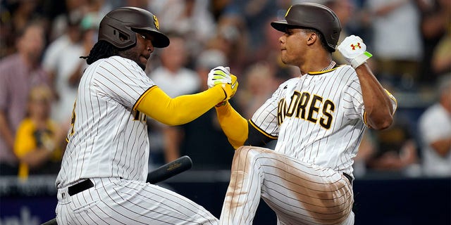 San Diego Padres' Juan Soto, right, celebrates with Josh Bell after hitting a home run against the San Francisco Giants during the fourth inning of a baseball game Tuesday, Aug. 9, 2022, in San Diego.