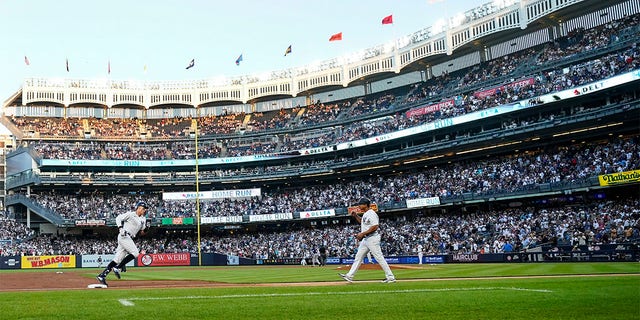 New York Yankees' Aaron Judge, left, runs the bases after hitting a two-run home run during the second inning of a baseball game against the Seattle Mariners, Monday, Aug. 1, 2022, in New York. 