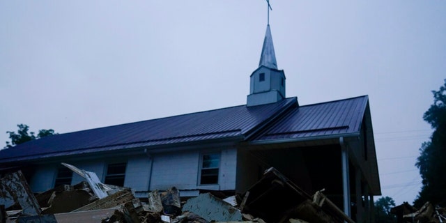 Piles of debris sit near a church after massive flooding on Friday, Aug. 5, 2022, in Lost Creek, Kentucky.