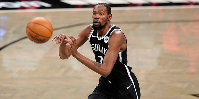 Brooklyn Nets forward Kevin Durant passes during the first half of a preseason game against the Washington Wizards Dec. 13, 2020, in New York. 