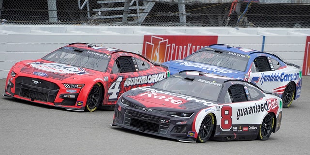 Kevin Harvick (4), Tyler Reddick (8) and Kyle Larson (5) race at Michigan International Speedway in Brooklyn, Michigan, Aug. 7, 2022.