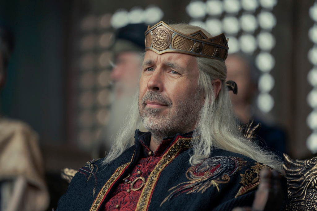 Paddy Considine as King Viserys wearing a crown and looking tense. 