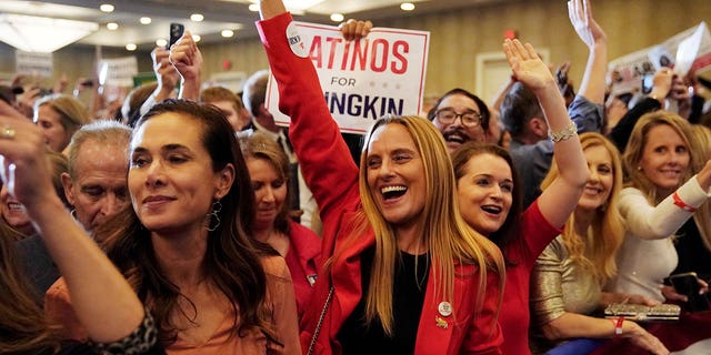 Hispanic supporters of Glenn Youngkin react as Fox News declares him the winner in the governor's race during an election night party in Chantilly, Virginia, Nov. 3, 2021.