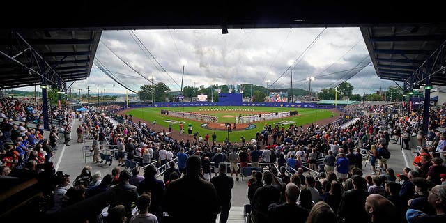 The Boston Red Sox line the third baseline and the Baltimore Orioles line the first baseline during the singing of the National Anthem before the Little League Classic baseball game in Williamsport, Pennsylvania, Sunday, Aug. 21, 2022.