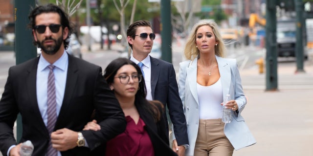 Lawrence and Bianca Rudolph's son, left, and daughter, back right, attending their father's trial for their mother's murder in U.S. District Court in Denver, July 13, 2022. 