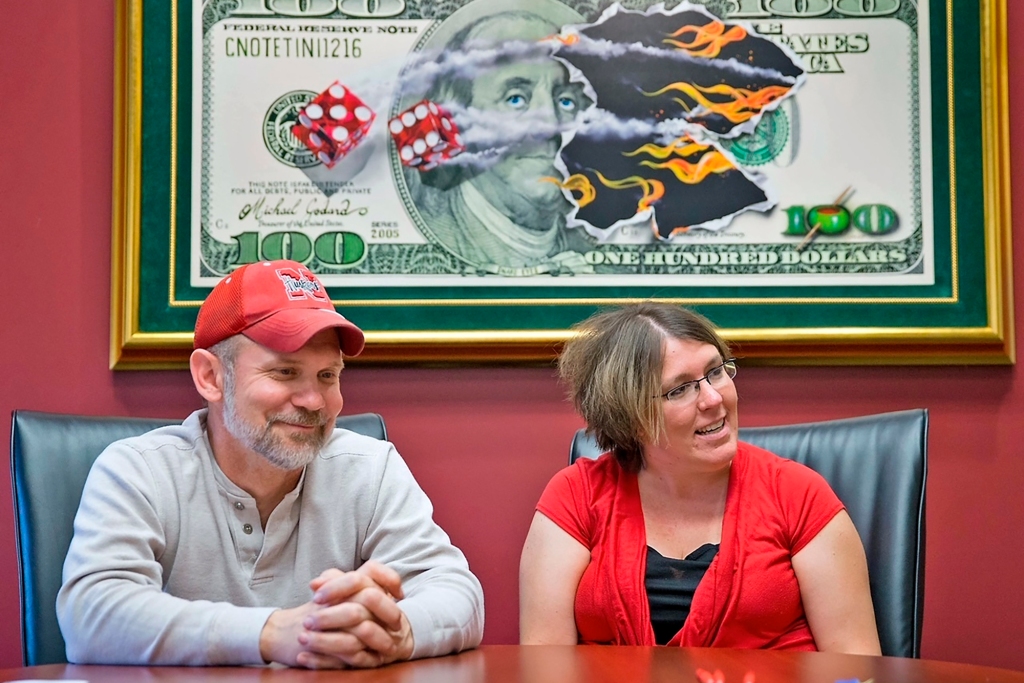 Powerball lottery winners David, left, and Erica Harrig, of Gretna, Neb., speak during an interview at the law office of their attorney Darren Carlson in Omaha, Neb., on Dec. 13, 2013.