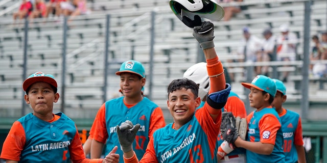 Nicaragua's Luis Garcia, #13, celebrates on the way back to the dugout after his three run home run off of Panama pitcher Gabriel de Gracia during the fourth inning of a baseball game at the Little League World Series tournament in South Williamsport, Pennsylvania, Tuesday, Aug. 23, 2022.