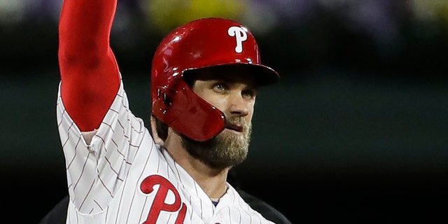 The Philadelphia Phillies' Bryce Harper gestures after hitting a double off Washington Nationals pitcher Jeremy Hellickson May 3, 2019, in Philadelphia.