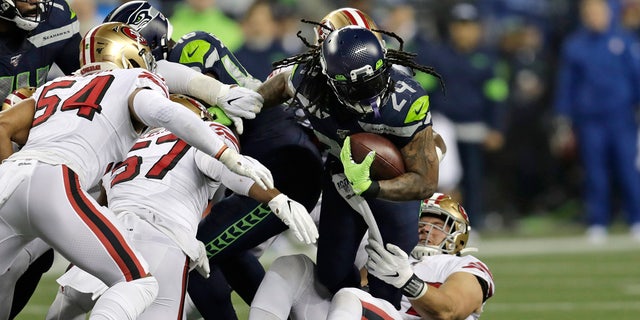 The Seattle Seahawks' Marshawn Lynch (24) carries on a fourth-and-1 but is pulled down short during the first half of a game against the San Francisco 49ers Dec. 29, 2019, in Seattle.