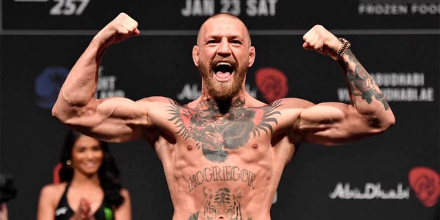 Conor McGregor of Ireland poses on the scale during the UFC 257 weigh-in at Etihad Arena on UFC Fight Island, Jan. 22, 2021, in Abu Dhabi, United Arab Emirates.