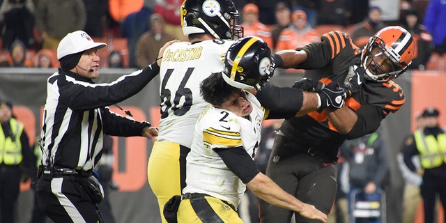 Quarterback Mason Rudolph of the Pittsburgh Steelers fights with defensive end Myles Garrett of the Cleveland Browns during the second half at FirstEnergy Stadium in Cleveland, Ohio, on Nov. 14, 2019.