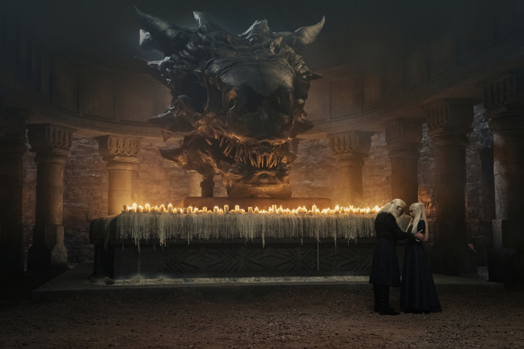 King Viserys (Paddy Considine) and his daughter, Princess Rhaenyra Targaryen, chat in front of a dragon skull after he names her his heir. 