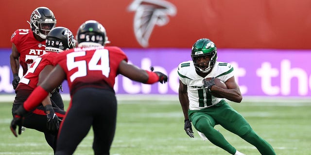 Denzel Mims (11) of the New York Jets runs with the ball against the Atlanta Falcons at Tottenham Hotspur Stadium in London, England, on Oct. 10, 2021.