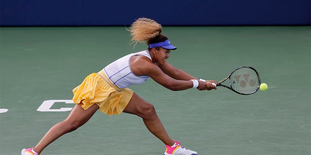 Naomi Osaka, of Japan, reaches for a shot from Zheng Qinwen, of China, at the Mubadala Silicon Valley Classic tennis tournament in San Jose, Calif., Tuesday, Aug. 2, 2022. 