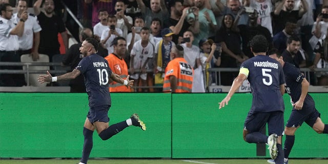 PSG's Neymar, left, celebrates after scoring his side's second goal during the French Super Cup final soccer match between Nantes and Paris Saint-Germain at Bloomfield Stadium in Tel Aviv, Israel, Sunday, July 31, 2022. 