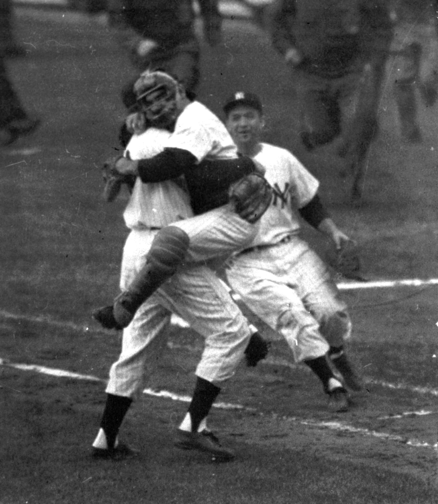 Don Larsen (left) is embraced by Yankees catcher Yogi Berra after Larsen pitched a perfect game on October 8, 1956.