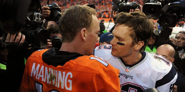 Denver Broncos QB Peyton Manning, left, is congratulated by New England Patriots Tom Brady after winning a game at Sports Authority Field at Mile High in Denver.