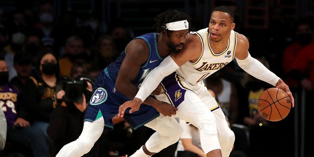 Russell Westbrook of the Lakers handles the ball against Patrick Beverley of the Minnesota Timberwolves at Crypto.com Arena on Jan. 2, 2022, in Los Angeles.