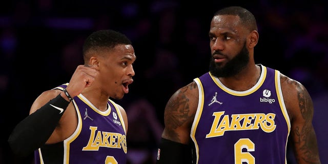 Russell Westbrook and LeBron James of the Lakers discuss a play during the Utah Jazz game on Feb. 16, 2022, in Los Angeles.