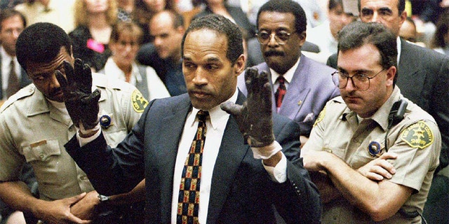 O.J. Simpson holds up his hands to the jury in this June 15, 1995 file photo.