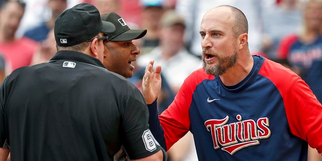 Minnesota Twins manager Rocco Baldelli, right, argues with umpires Marty Foster, left, and Alan Porter after a review reversed a call that originally had Toronto Blue Jays' Whit Merrifield out at home in the 10th inning on Sunday, Aug. 7, 2022, in Minneapolis. The Blue Jays won, 3-2, in 10 innings.