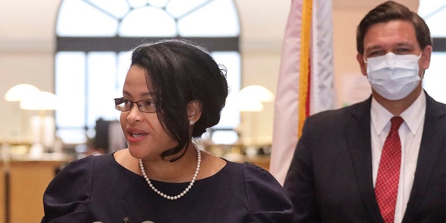 Renatha Francis, a Palm Beach County circuit judge, gives remarks after being appointed by Gov. Ron DeSantis, right, to the Florida Supreme Court during a news conference in downtown Miami on May 26, 2020.