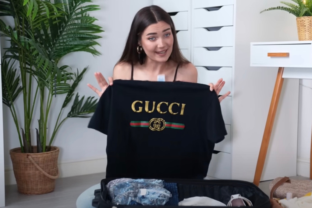 Roxi holding up Gucci t shirt
