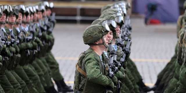 Russian service members march during a military parade on Victory Day, which marks the 77th anniversary of the victory over Nazi Germany in World War Two