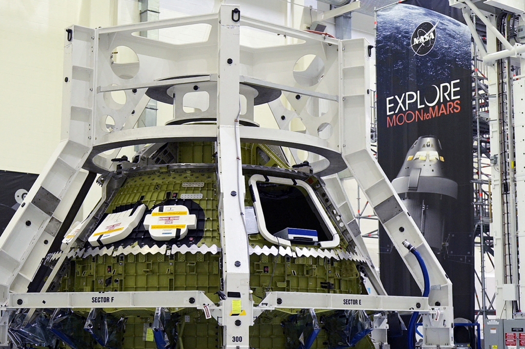 NASA's Orion crew module for the Artemis 3 mission stands in the Operations and Checkout Building during a media tour at Cape Canaveral, Florida.