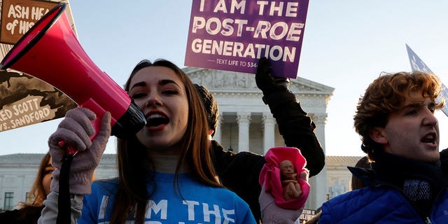 Pro-life demonstrators protest in front of the Supreme Court building on the day arguments were heard in the Mississippi abortion rights case Dobbs v. Jackson Women's Health, in Washington, Dec. 1, 2021.