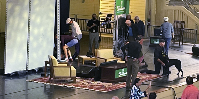 Author Salman Rushdie, behind screen left, is tended to after he was attacked during a lecture on Friday, Aug. 12, at the Chautauqua Institution in Chautauqua, N.Y.