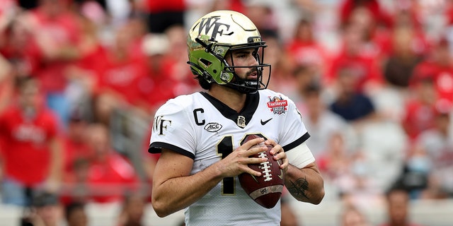 Sam Hartman #10 of the Wake Forest Demon Deacons looks to pass against the Rutgers Scarlet Knights during the TaxSlayer Gator Bowl at TIAA Bank Field on Dec. 31, 2021 in Jacksonville, Florida.