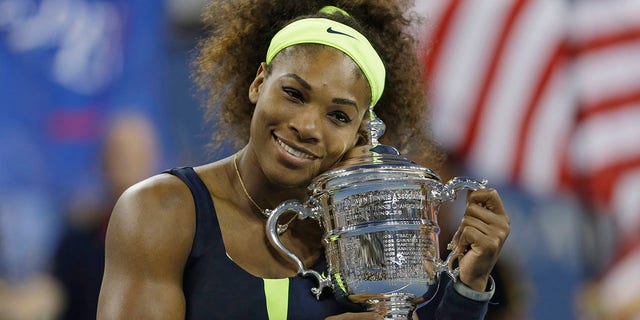 Serena Williams holds the championship trophy after beating Victoria Azarenka, of Belarus, in the championship match at the 2012 US Open tennis tournament in New York. 