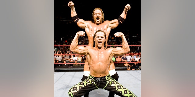 Shawn Michaels poses with Triple H.