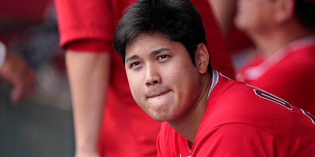 Los Angeles Angels' Shohei Ohtani sits in the dugout during the first inning of a baseball game against the Texas Rangers Sunday, July 31, 2022, in Anaheim, Calif.