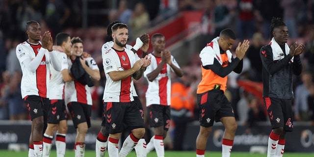 Southampton players applaud supporters at the end of the English Premier League soccer match between Southampton and Chelsea at St Mary's Stadium, Southampton, England, Tuesday, Aug. 30, 2022.