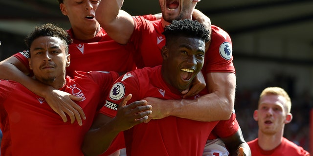 Nottingham Forest's Taiwo Awoniyi, center, celebrates with his teammates after scoring against West Ham at the City ground in Nottingham, England, Sunday, Aug. 14, 2022.