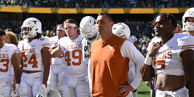 A dejected Texas Longhorns head coach Steve Sarkisian heads toward the locker room.