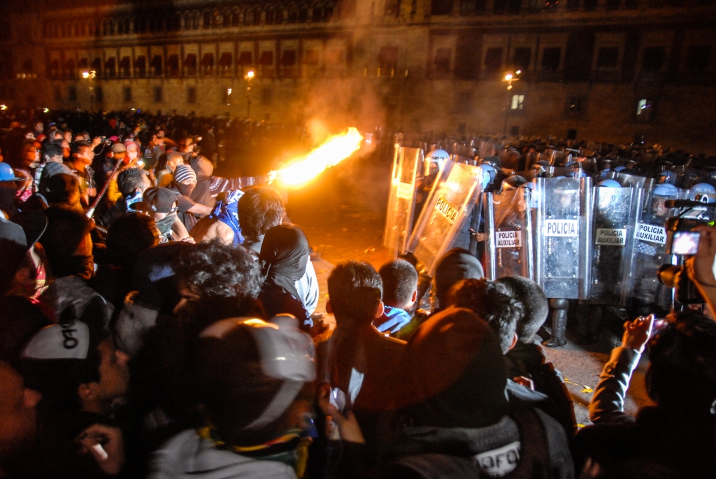Students and anarchists clash with police during a march in Mexico City calling for the safe return of 43 missing Ayotzinapa students on November 20, 2014.