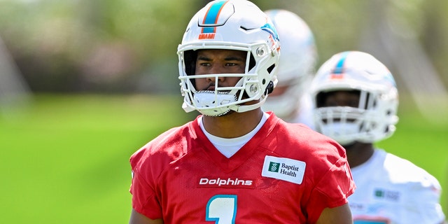 Miami Dolphins quarterback Tua Tagovailoa (1) stretches during the first mandatory minicamp at the Baptist Health Training Complex June 1, 2022, in Miami Gardens, Fla.