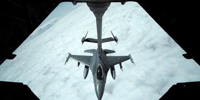 FILE - A U.S. Air Force F-16 receives fuel from a fuel boom suspended from a US Air Force KC-10 Extender during mid-air refueling support to Operation Inherent Resolve over Iraq and Syria air space, March 15, 2017.